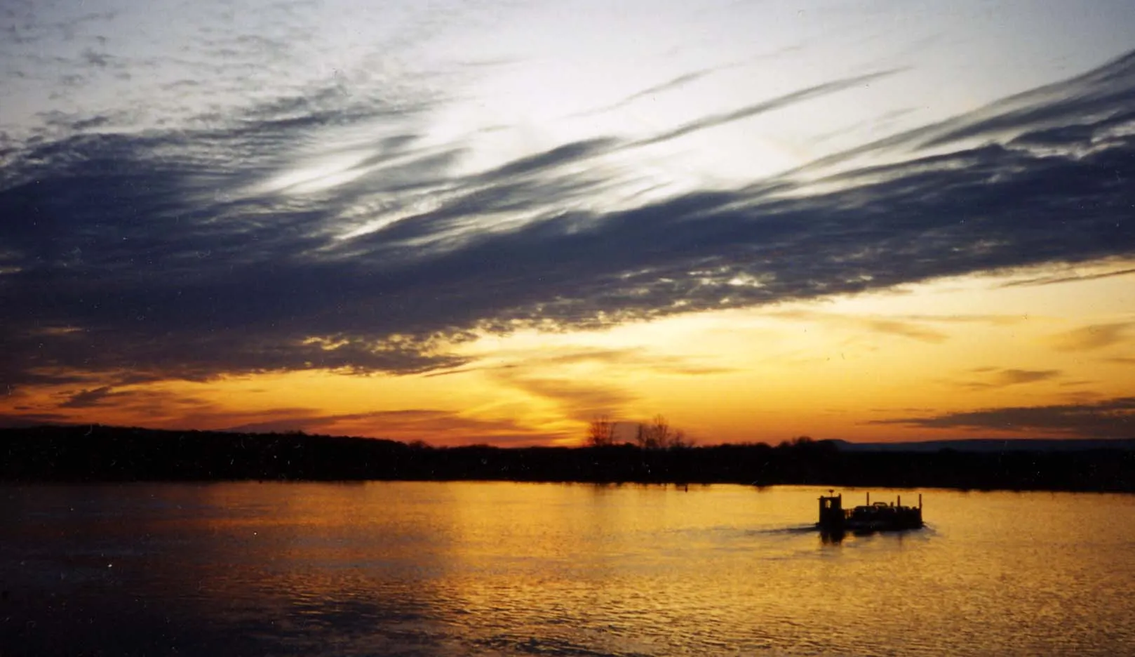 Sunset over the Mississippi River at Memphis with dark clouds