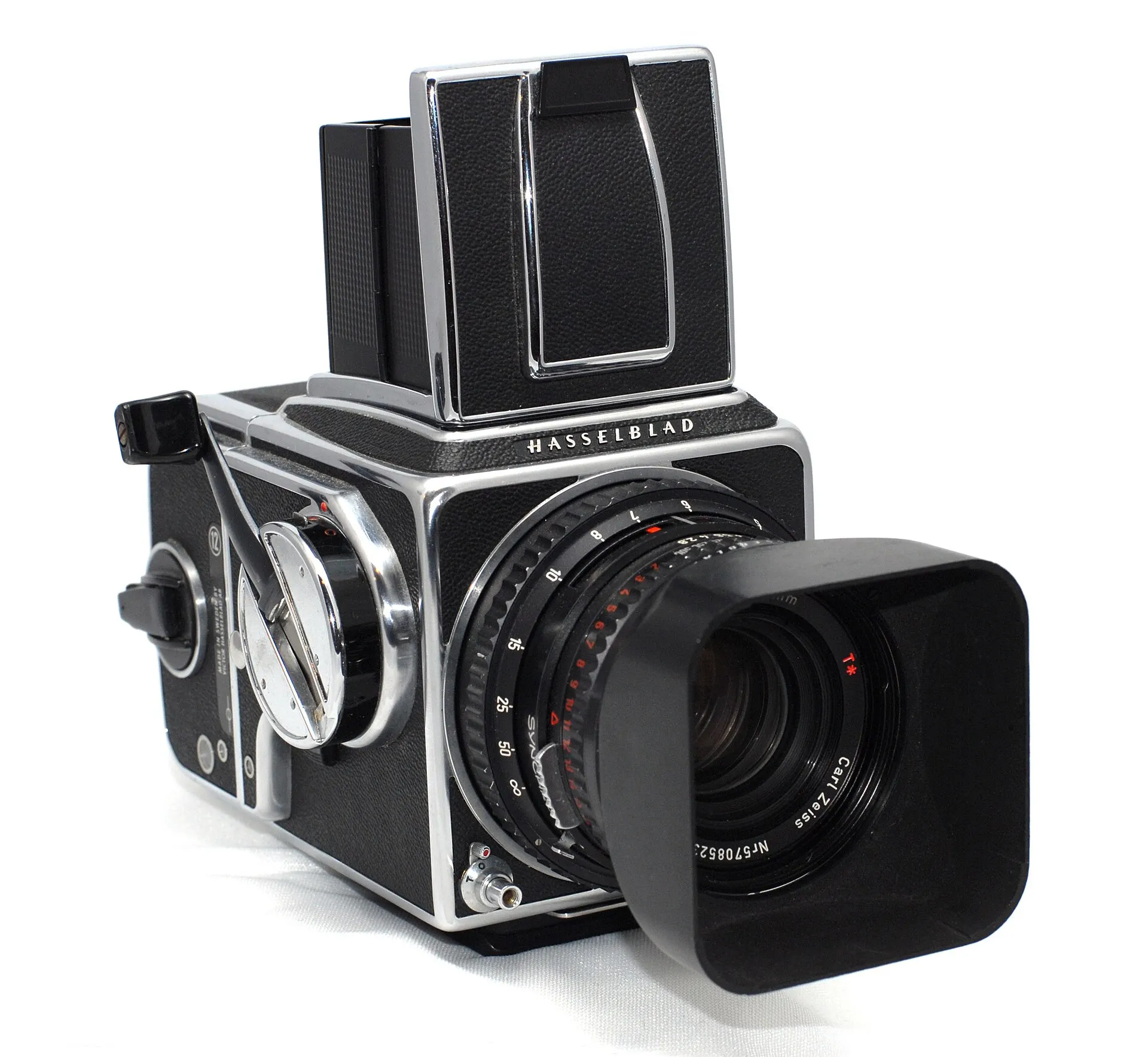Chrome and black Hasselblad 500C/M with folded waist-level finder, film back and square lens hood on a white background