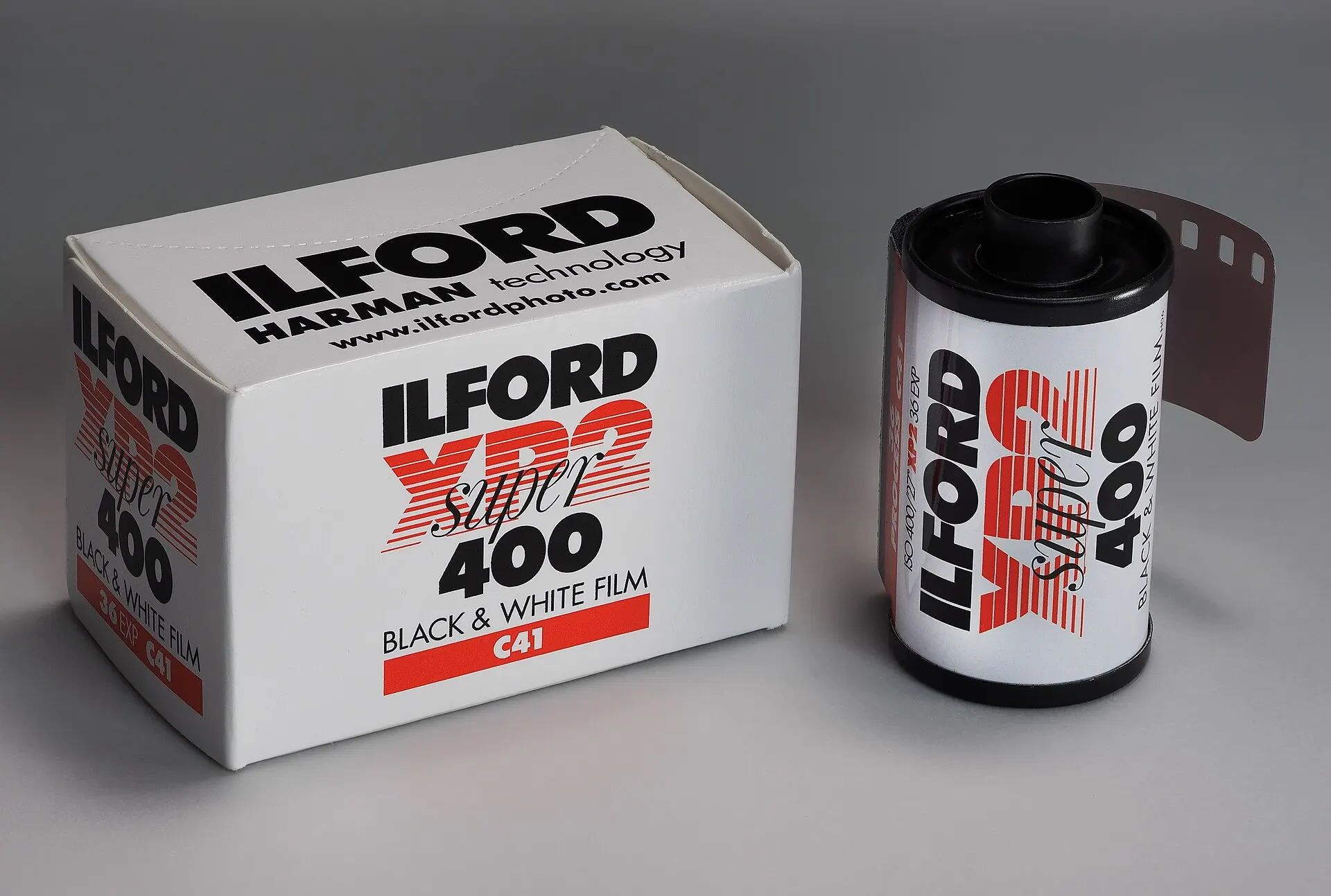 A box of Ilford XP2 Super 400 35mm film next to its cassette, labeled C41 black and white film