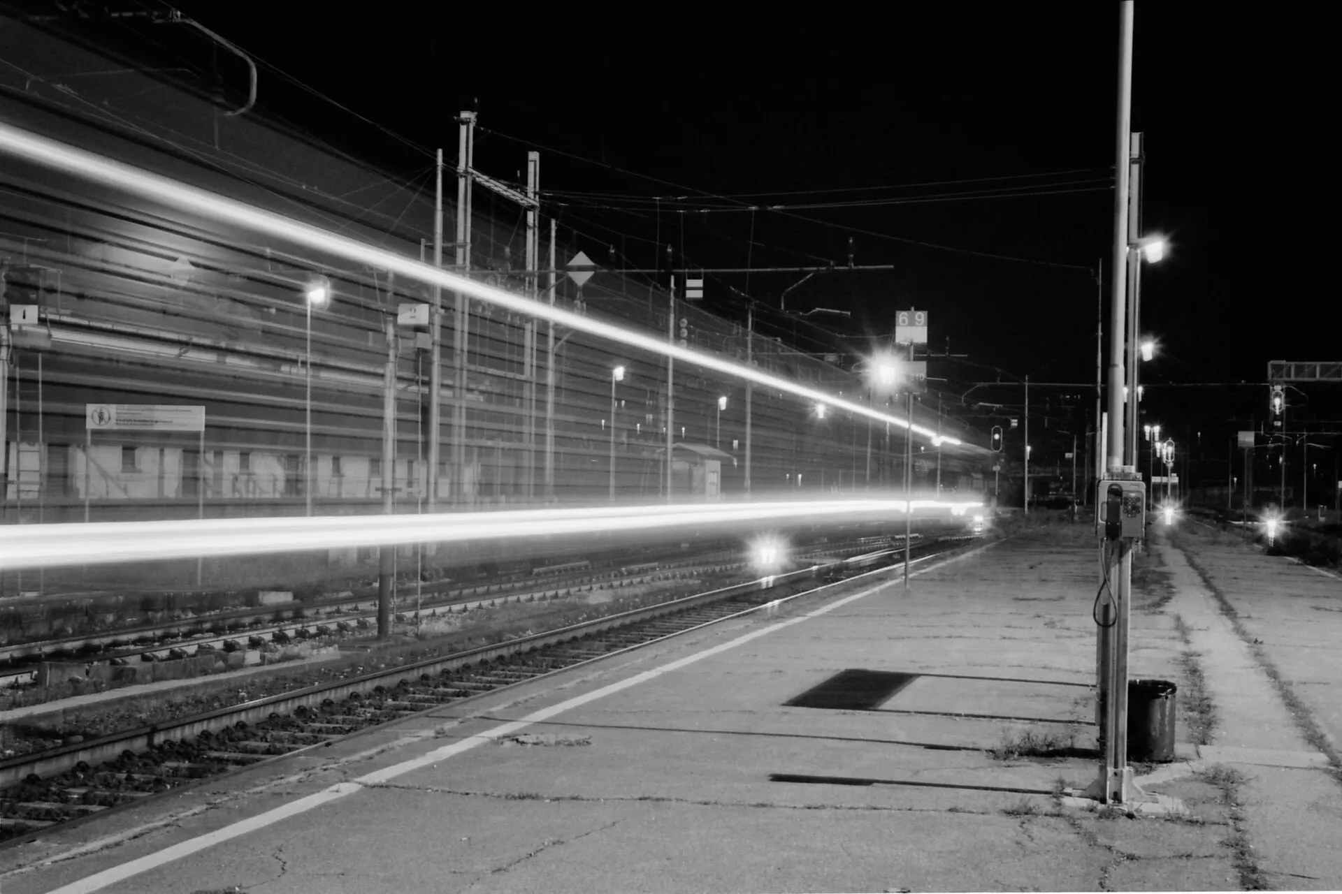 Light trails of a train at a station platform at night