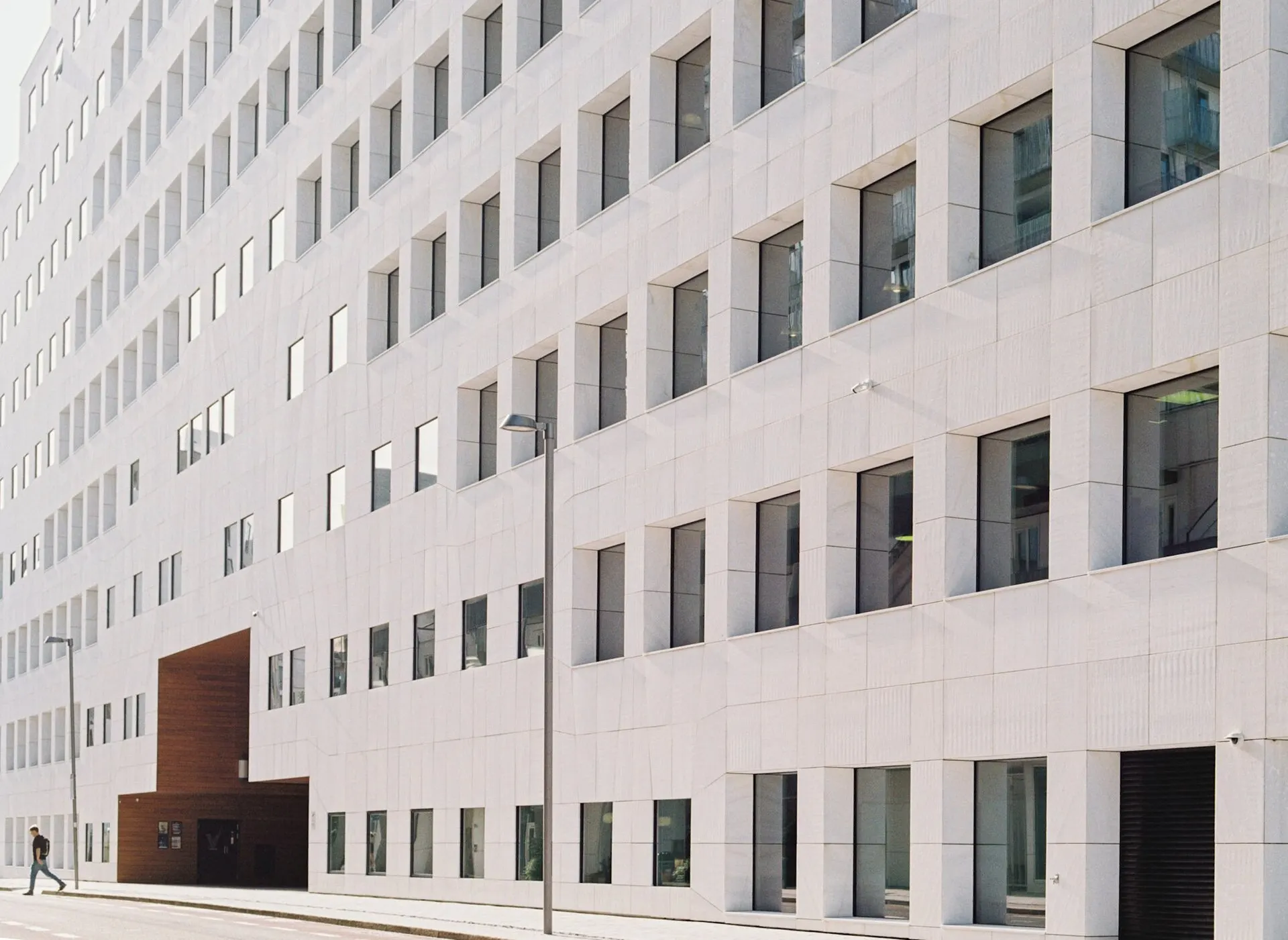 Plain white office building facade with rows of square windows