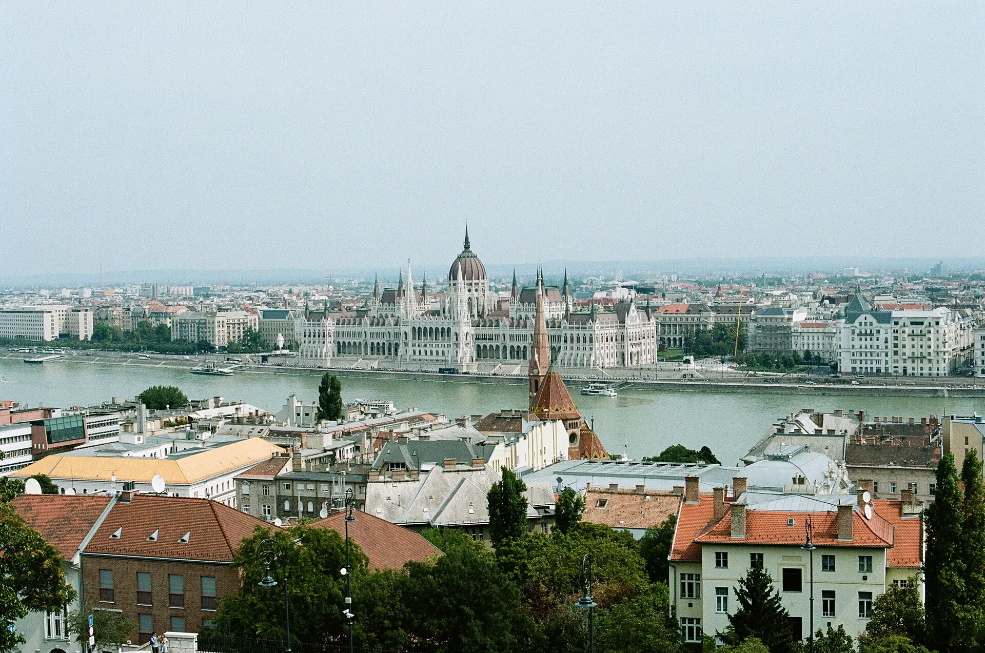 View over red rooftops and the Danube to the Hungarian Parliament building in Budapest