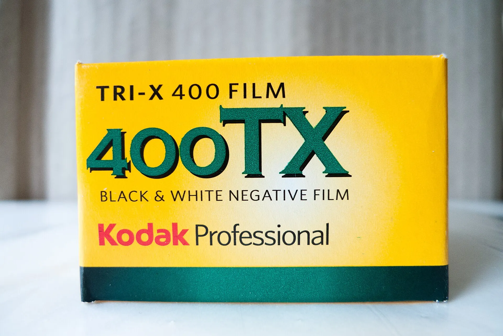 Yellow box of Kodak Professional Tri-X 400 (400TX) black-and-white negative film on a white table