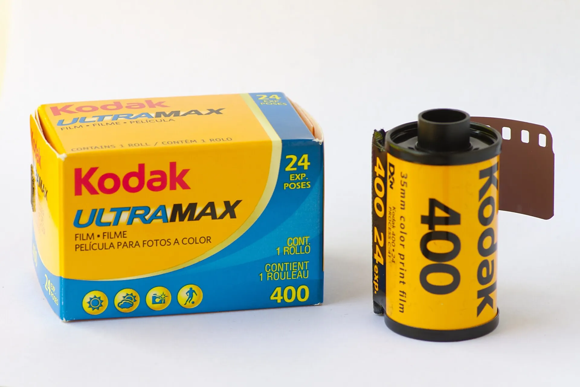 A Kodak Ultramax 400 35mm film cartridge beside its yellow and blue 24-exposure box on a white background