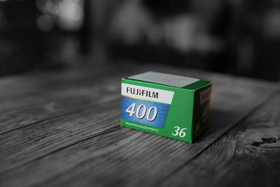 A box of Fujifilm 400 35mm color film on a wooden table