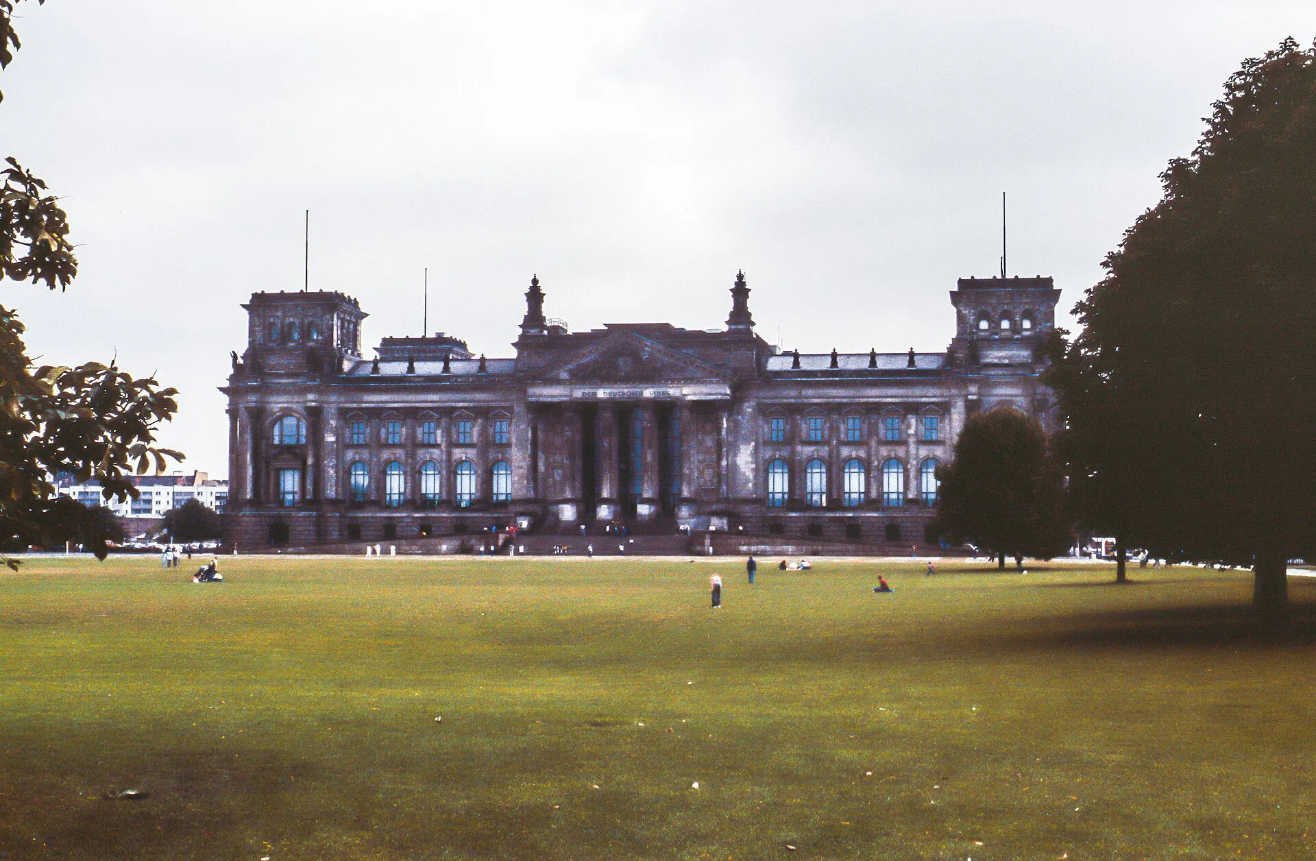 The Reichstag building in Berlin seen across a wide lawn