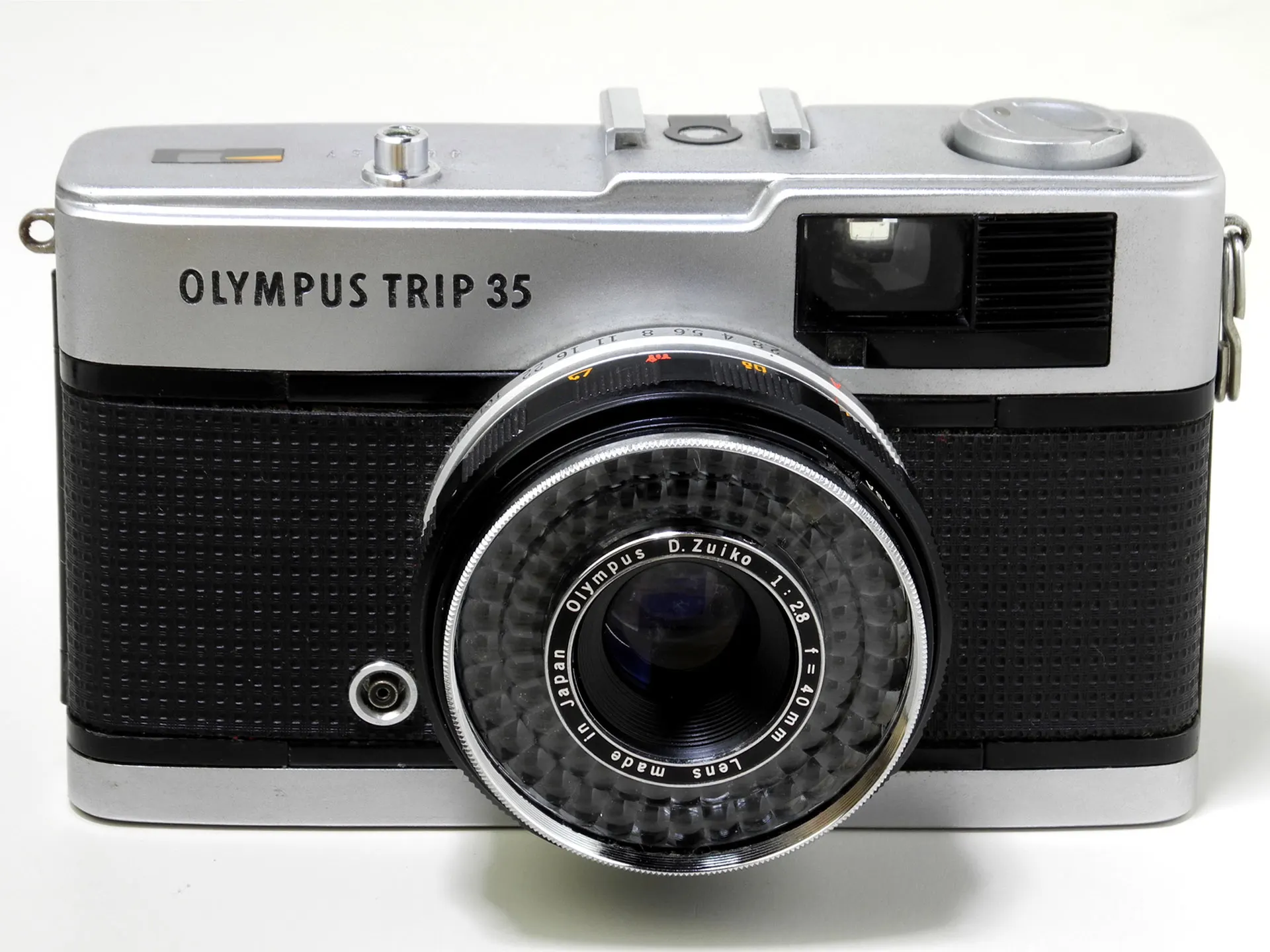 Olympus Trip 35 seen from the front, showing the selenium cell ring around the 40mm lens and the viewfinder window